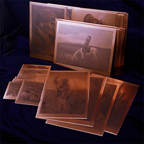 a display of the curtis photogravure plates on a black background